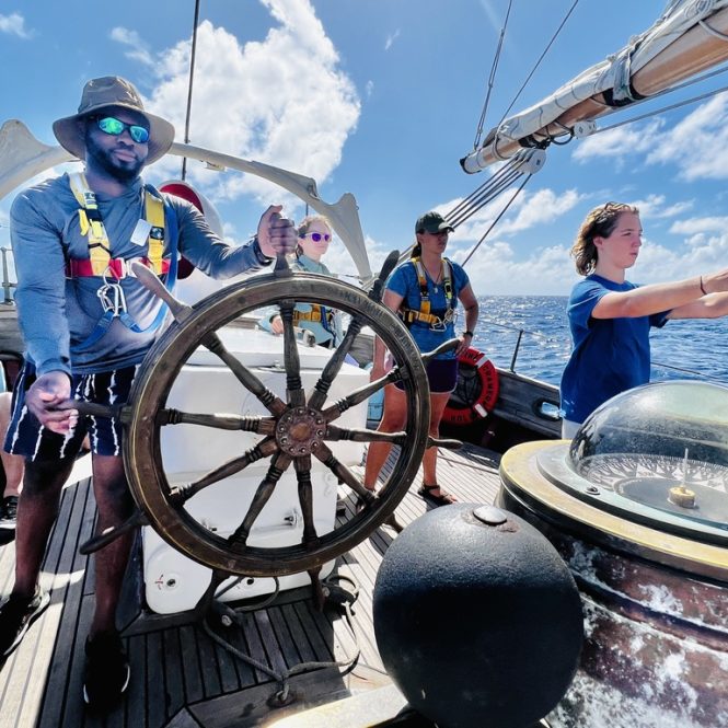 man driving a large sailing ship